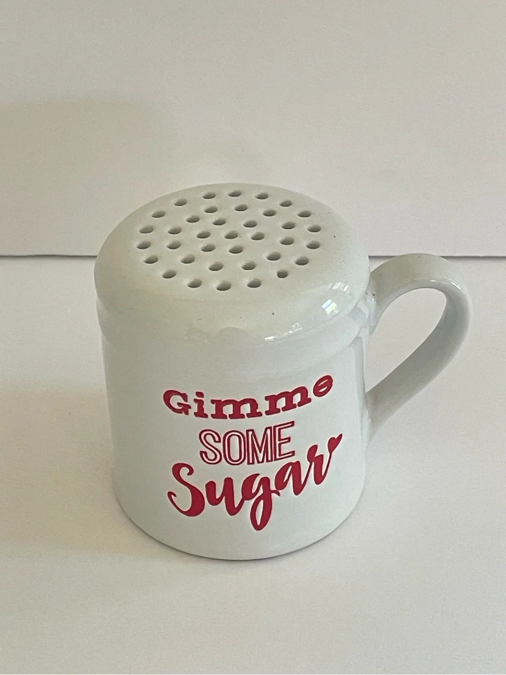 Red and White Ceramic Shaker with “Gimme some Sugar” writing
